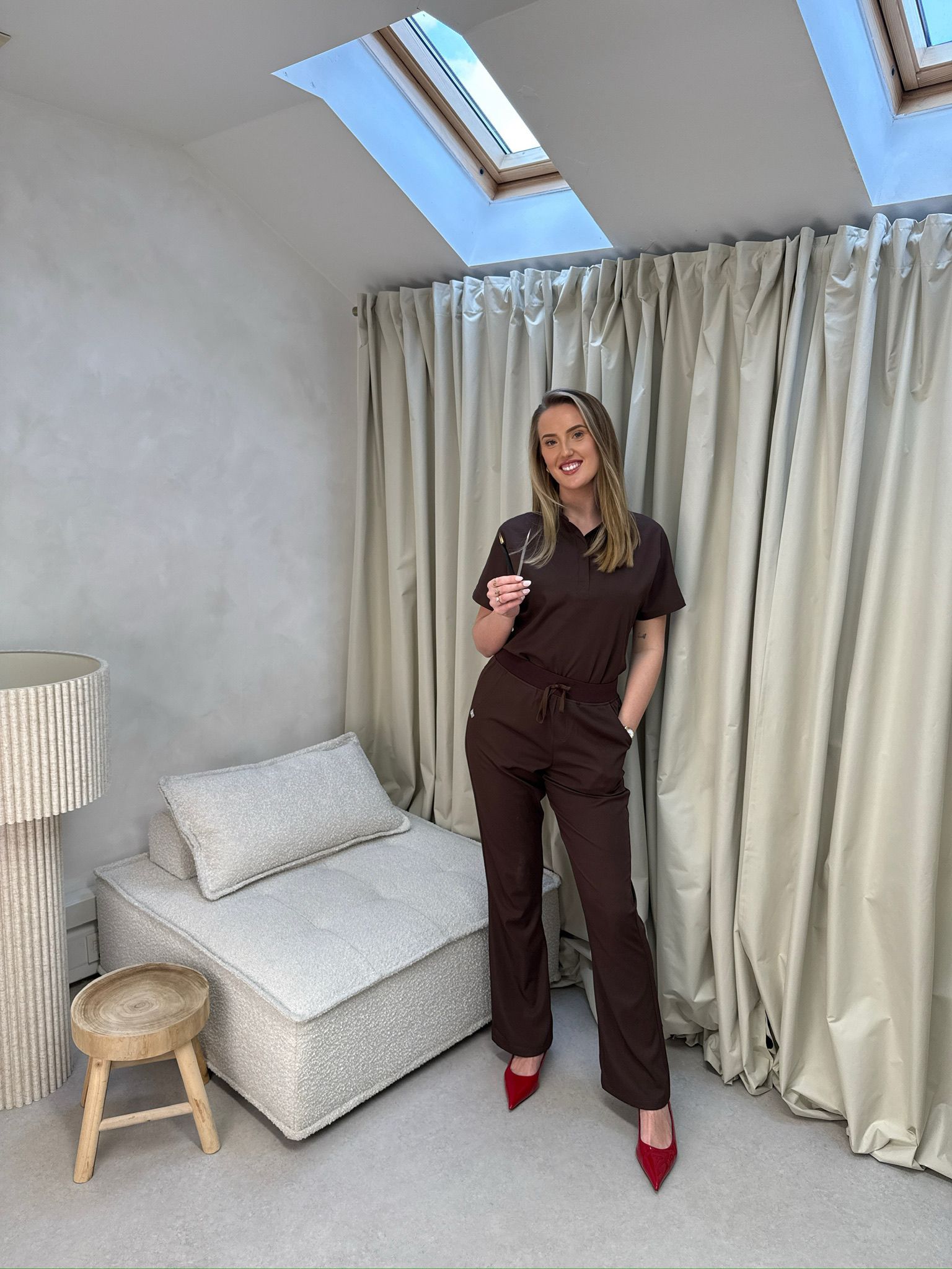 The owner of Refined and Radiant standing inside the studio